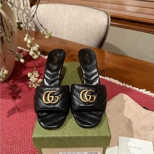Gucci Black Leather Mules with Gold Emblem